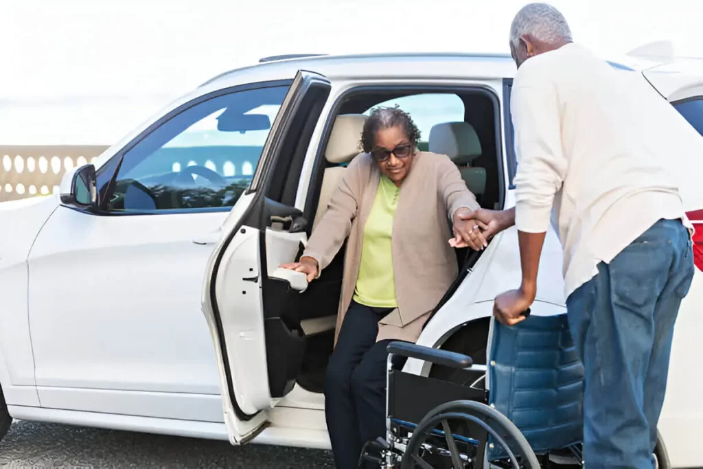 NYC wheelchair transportation driver assisting passenger into ambulette van