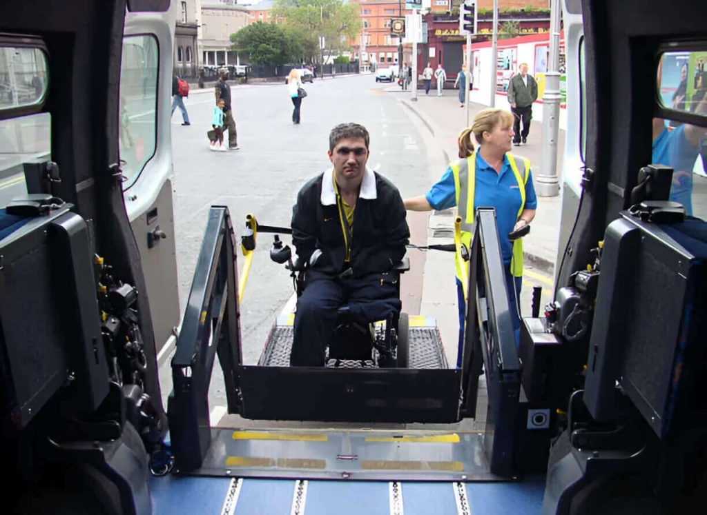 Wheelchair cab in NYC assisting a passenger