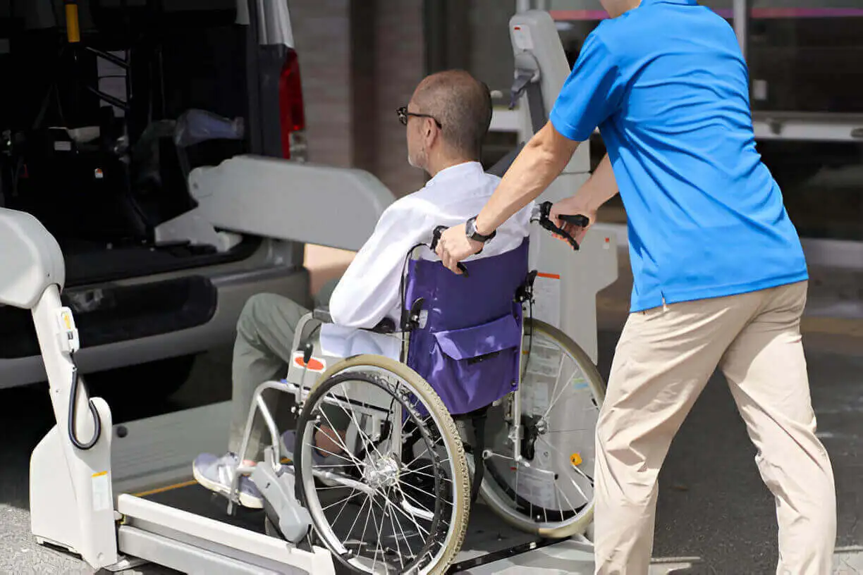 Wheelchair taxi for hospital transport - NYC Wheelchair van loading patient at Mount Sinai Hospital with ADA-compliant ramp.