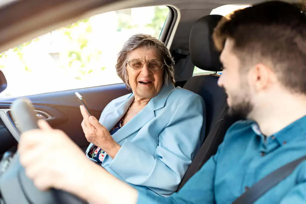 Driver explaining ambulette services to a senior woman