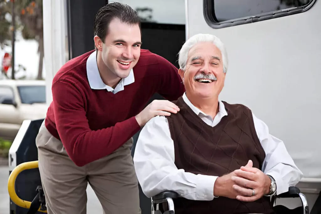 Smiling senior in a wheelchair receiving help from shuttle driver in NYC