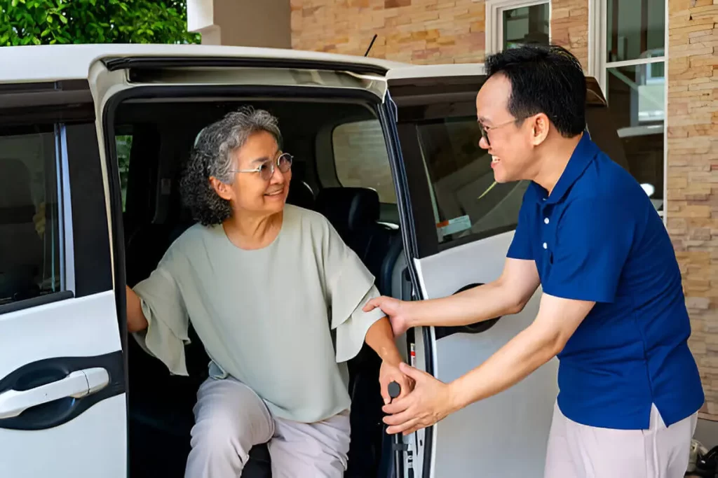 Trained ambulette driver assisting senior in NYC