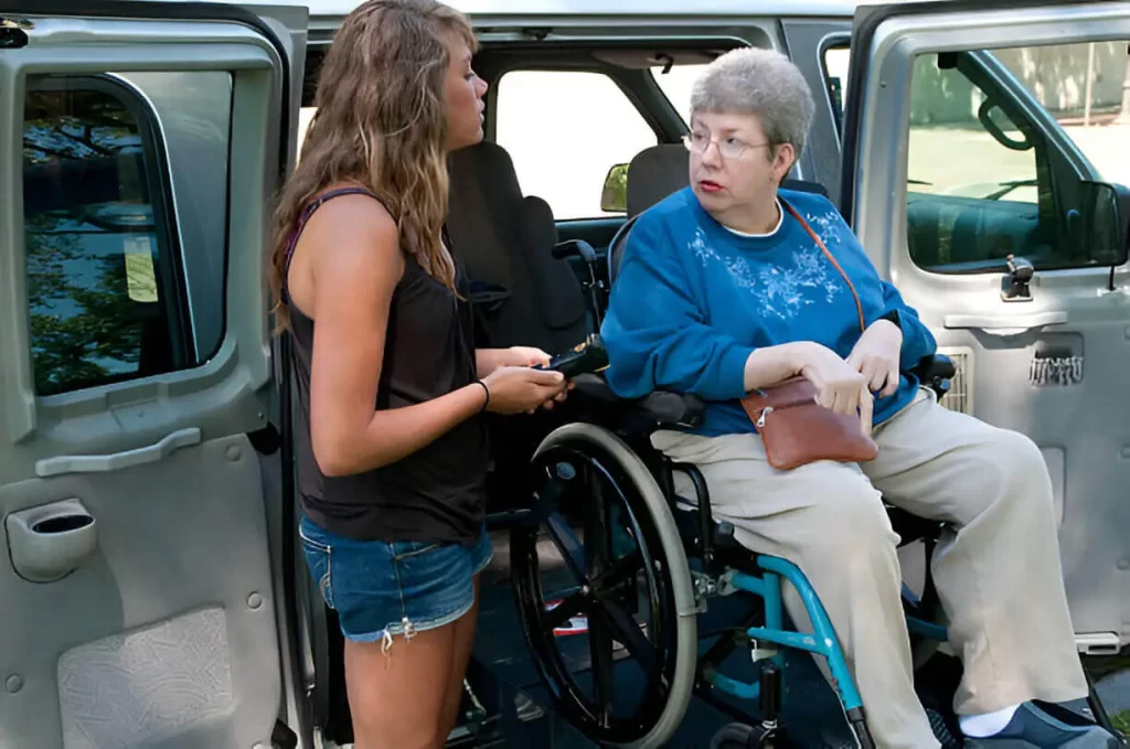 Senior citizen receiving help from trained driver for wheelchair transport near me
