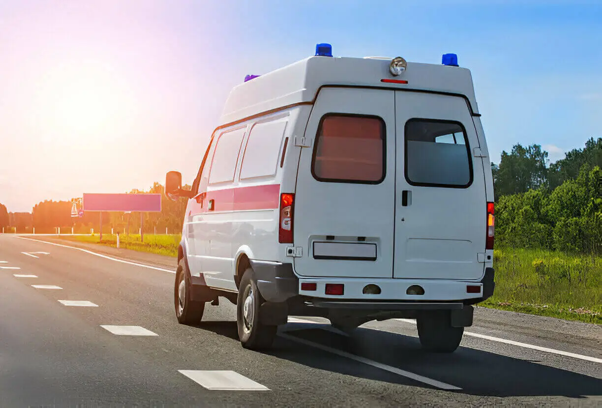 Ambulette traveling on road for long-distance patient transport