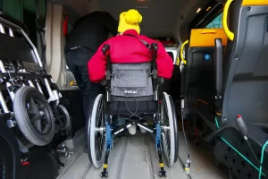 Wheelchair user entering an accessible taxi van in Manhattan