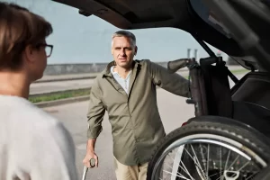 Senior in wheelchair smiling while entering a transport van in NYC