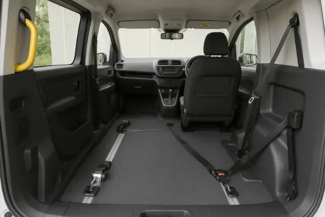 Interior of modern wheelchair accessible taxi with ample space and safety features.